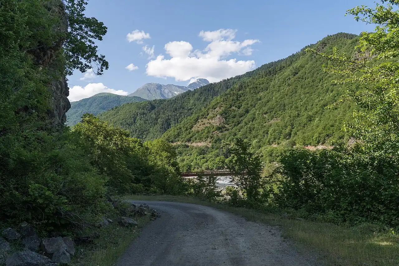 Gravel road and old bridge in the mountains of Oni municipality, Georgia