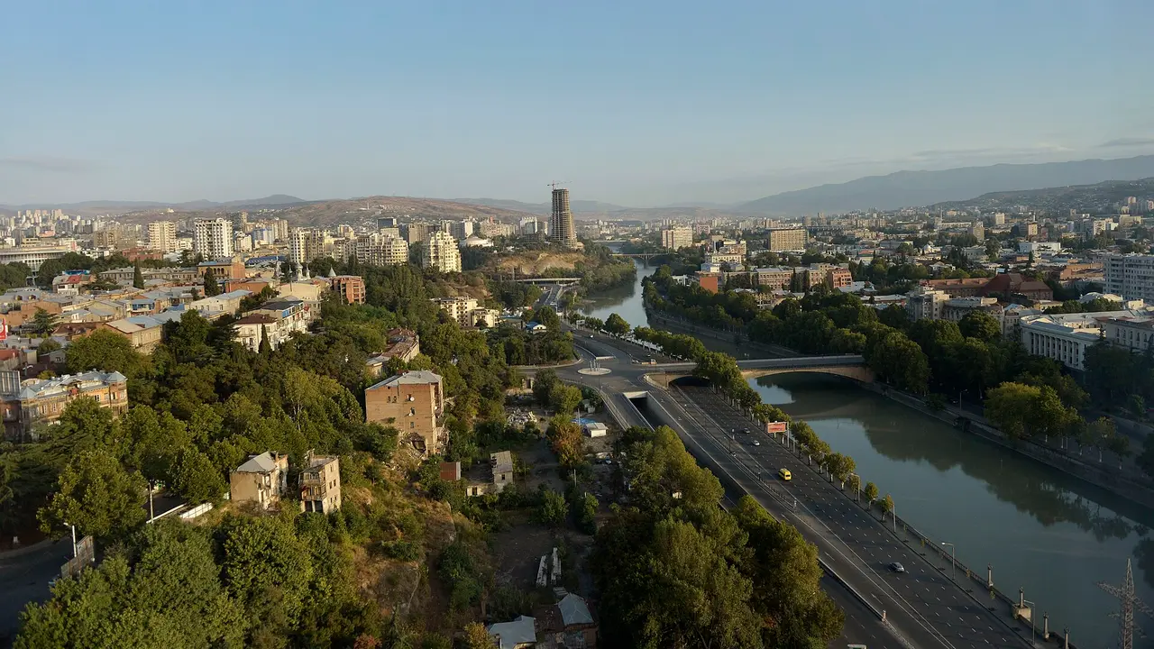 Panorama of Tbilisi rooftops with mountains on the horizon