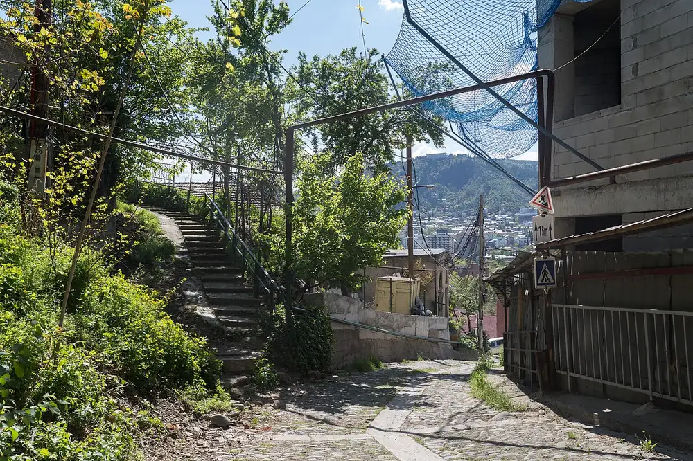 Quiet residential street in Tbilisi with parked cars