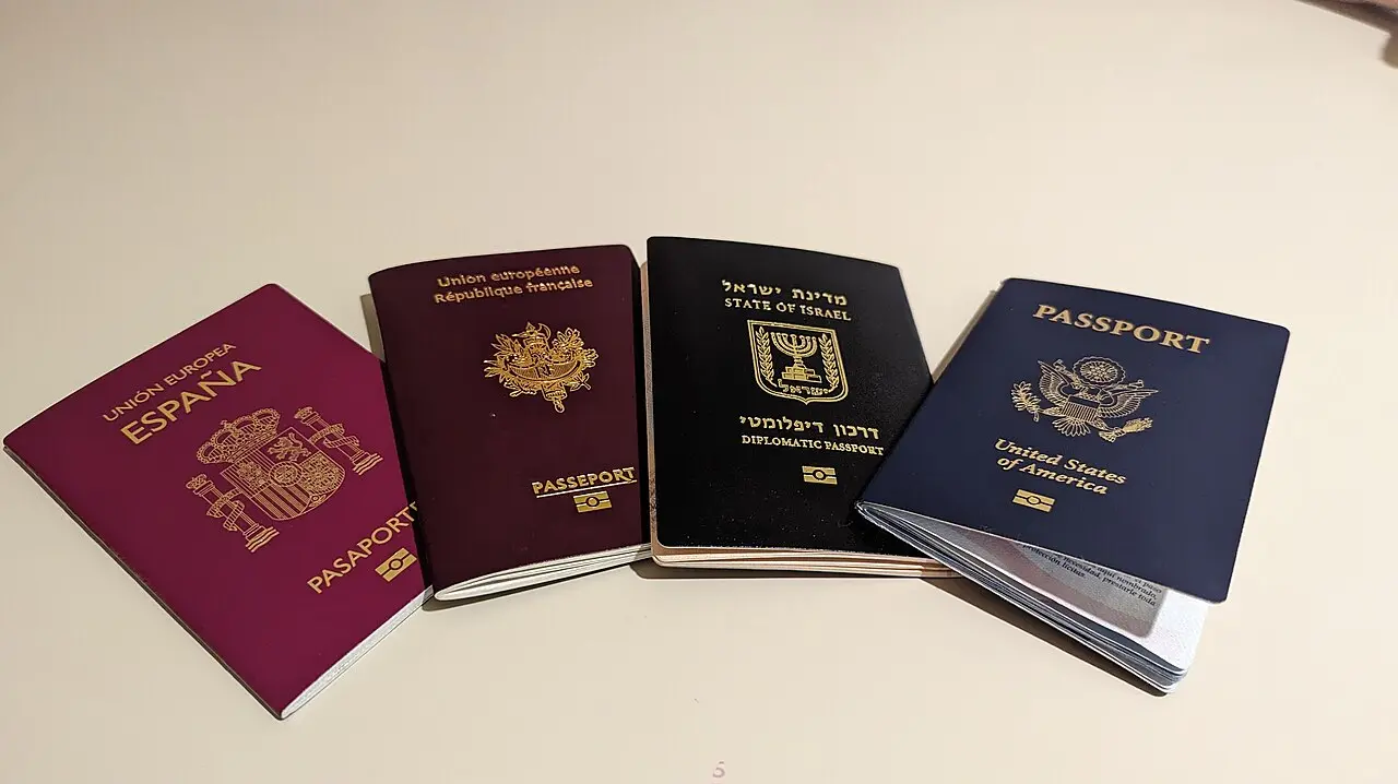 Passports of Spain, France, Israel and the United States laid out on a table