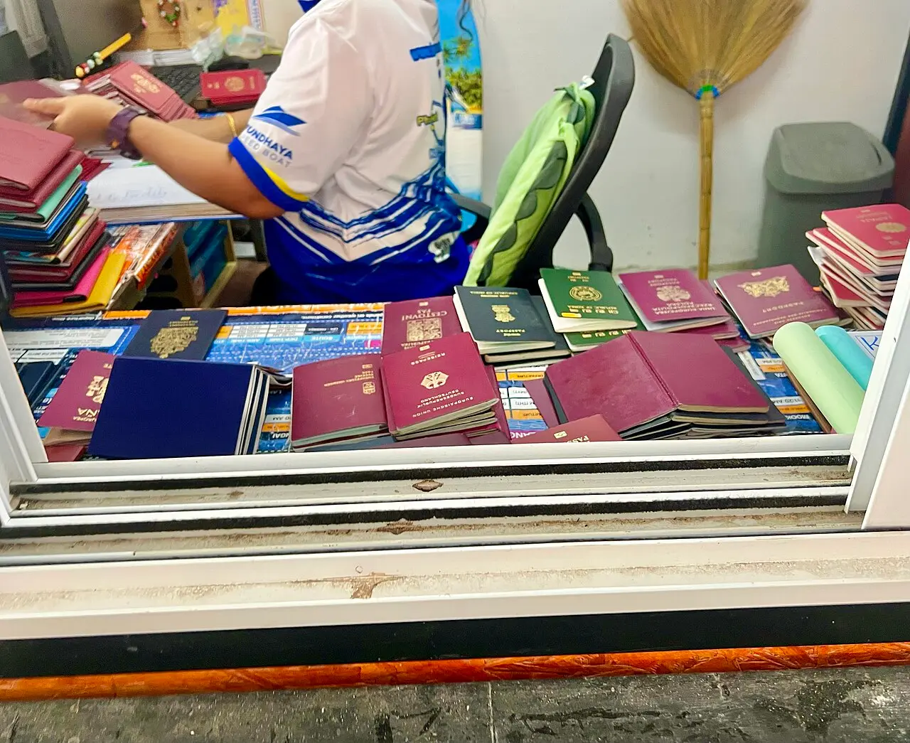 A pile of passports of different countries stacked on a travel desk