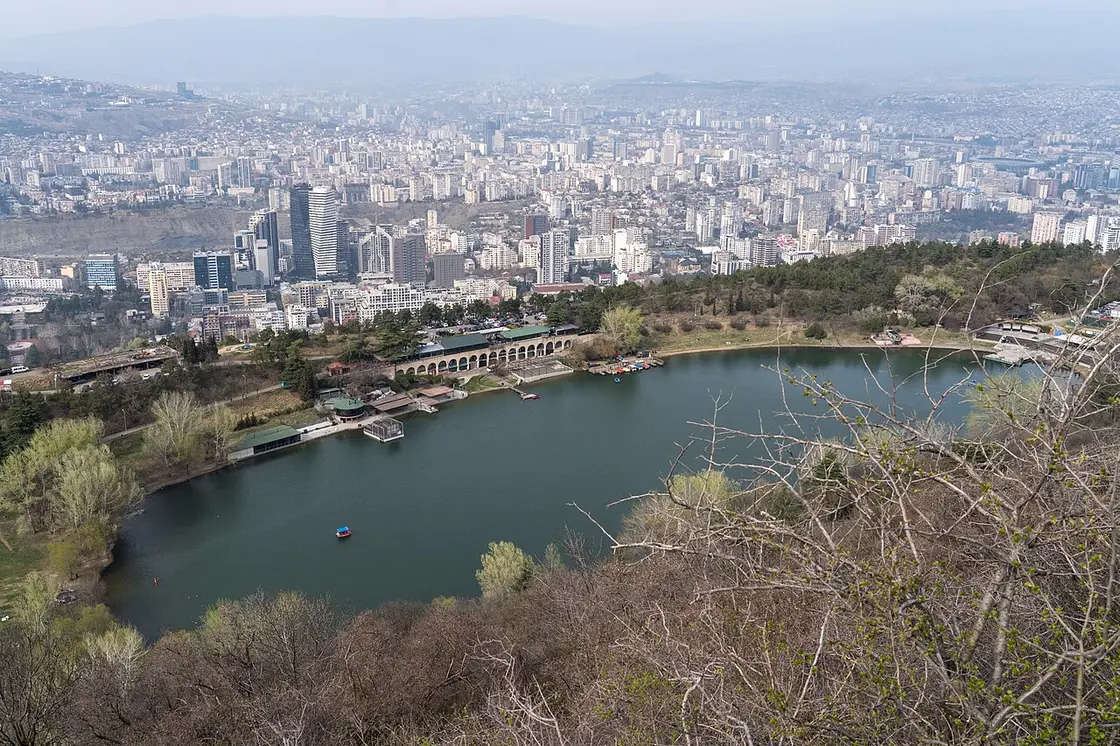 Turtle Lake in the hills, with a panorama of Tbilisi behind it
