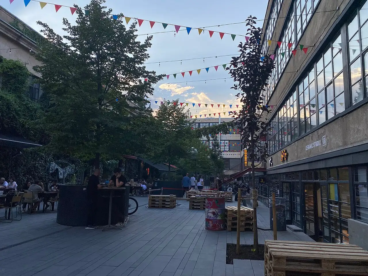 The Fabrika courtyard in Tbilisi by day: a cafe, bunting and tables