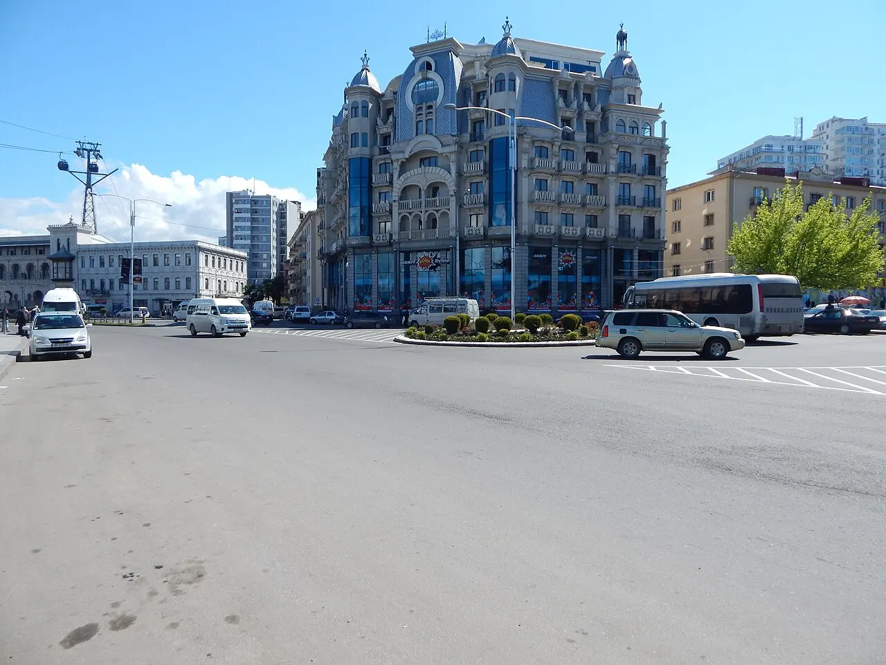 Ornate blue building at a Batumi street junction with the Argo cable car line overhead