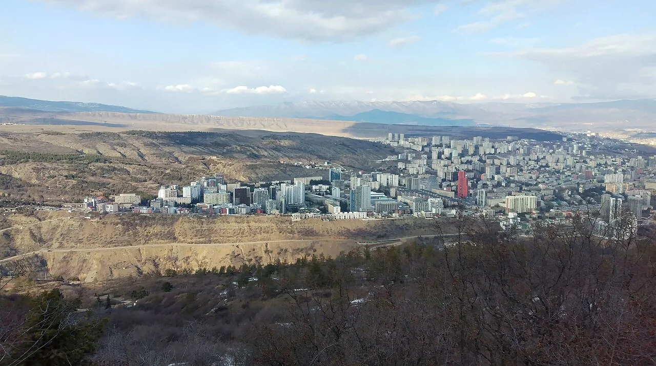 A panorama of Saburtalo with new residential towers and mountains on the horizon