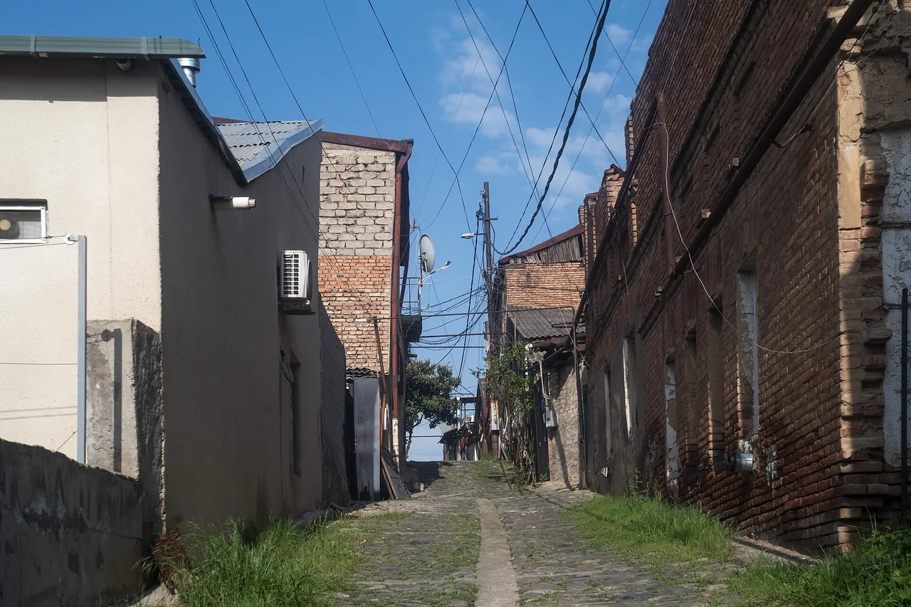 A narrow cobbled lane climbing steeply between old houses