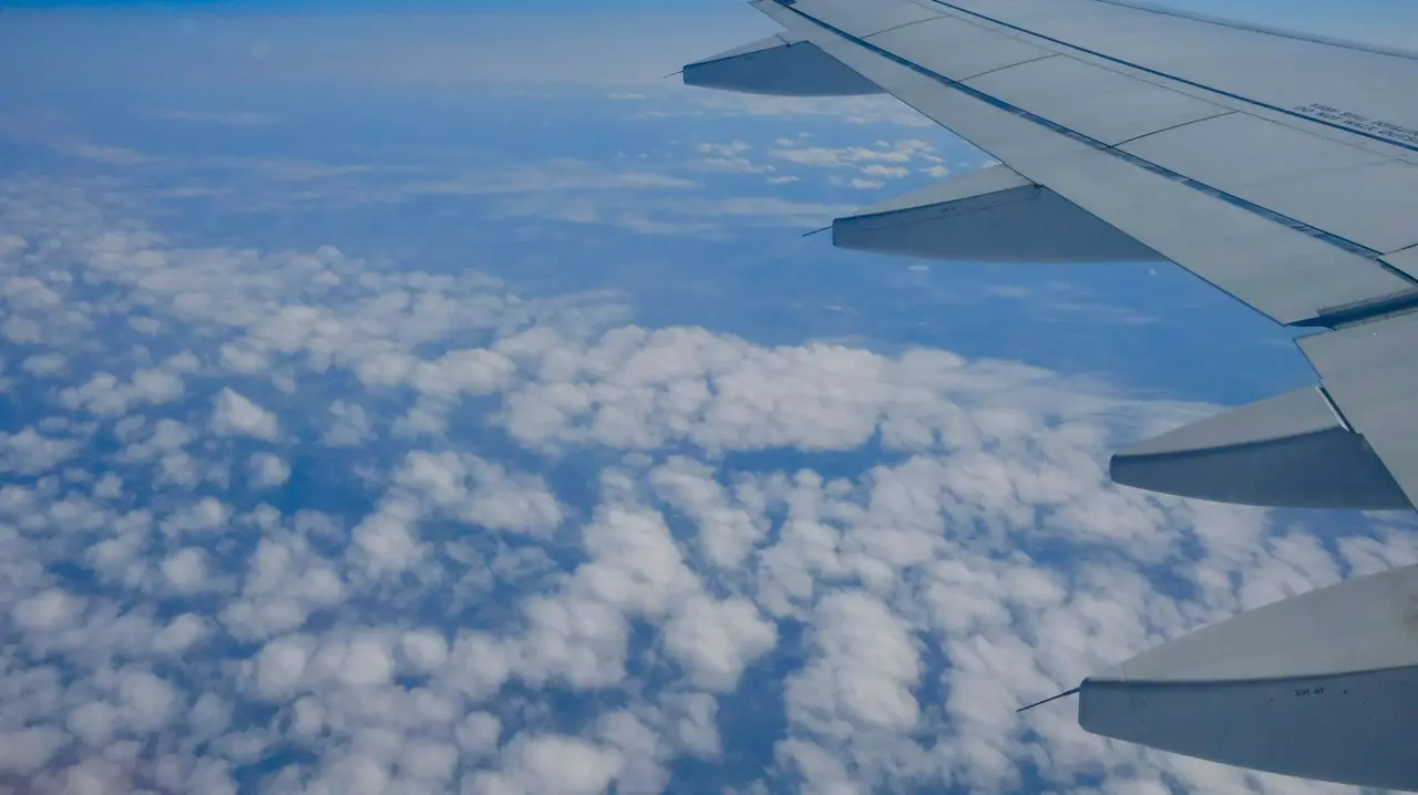 Aircraft wing above the clouds on the way to Georgia