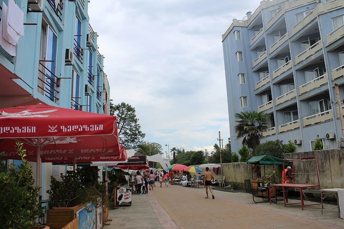 The pedestrian promenade at Ureki lined with cafes and market stalls in summer