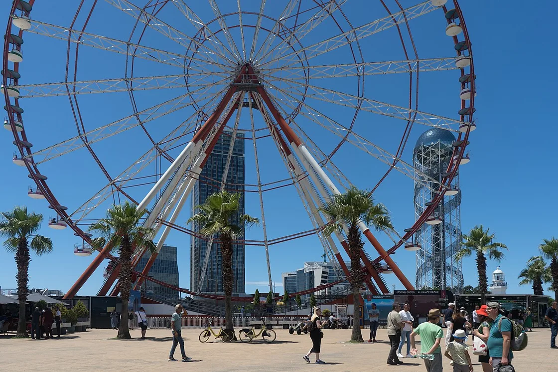 The Ferris wheel and palm trees on the Batumi seafront on a sunny day
