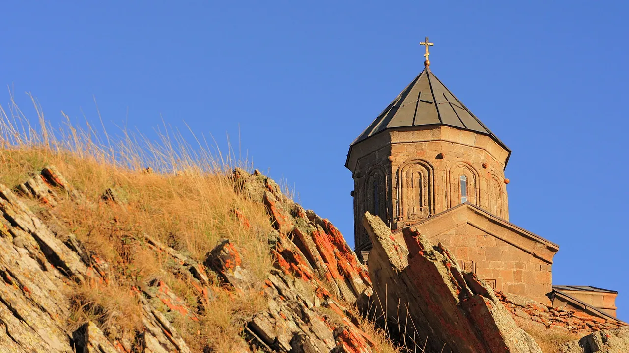 Gergeti Trinity Church against the Kazbegi mountains - the classic Georgia postcard