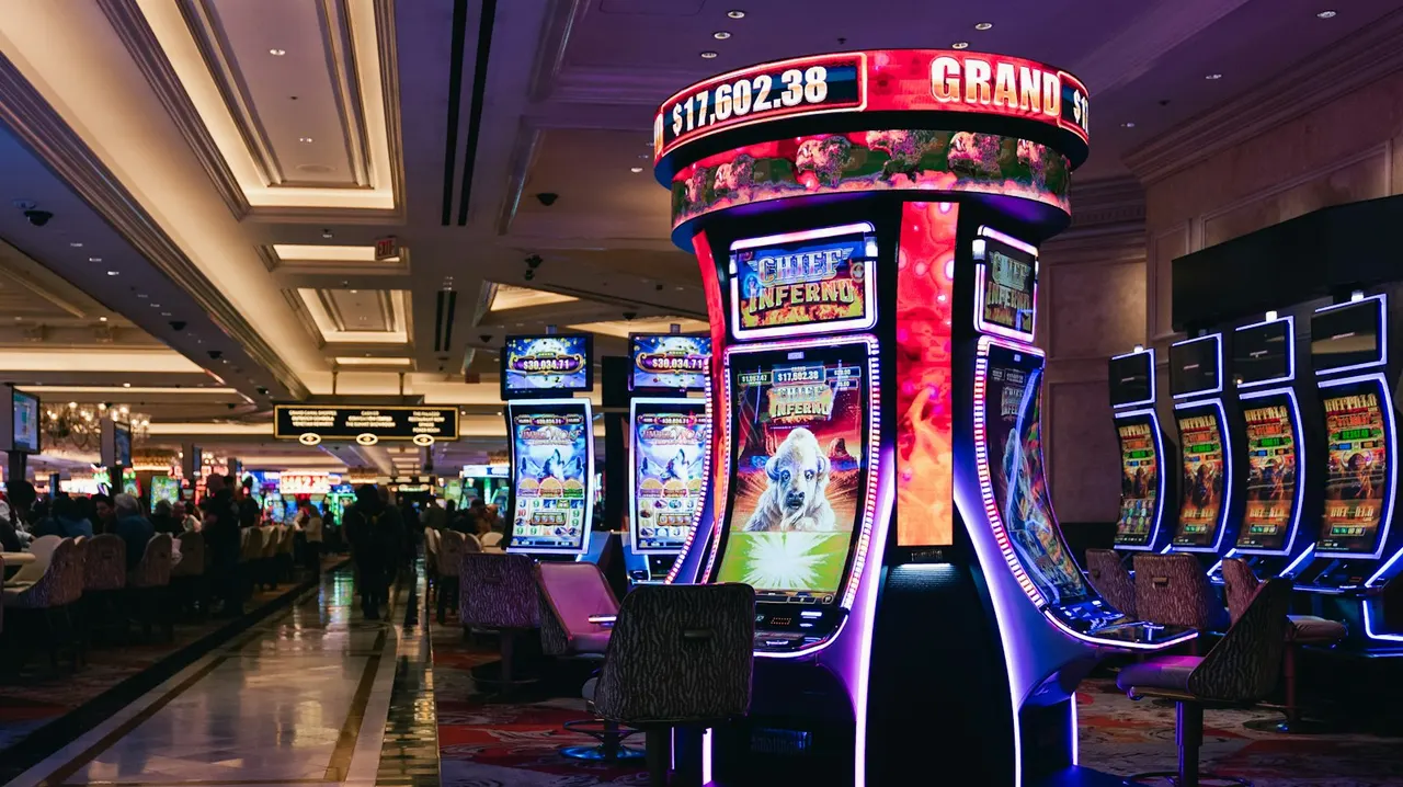 Rows of illuminated slot machines in a casino hall