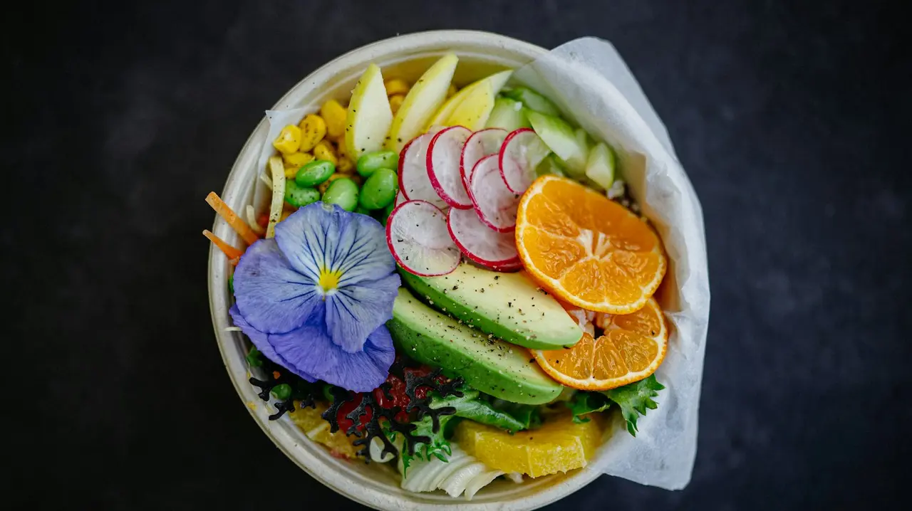 A vegan bowl with fresh vegetables and fruit