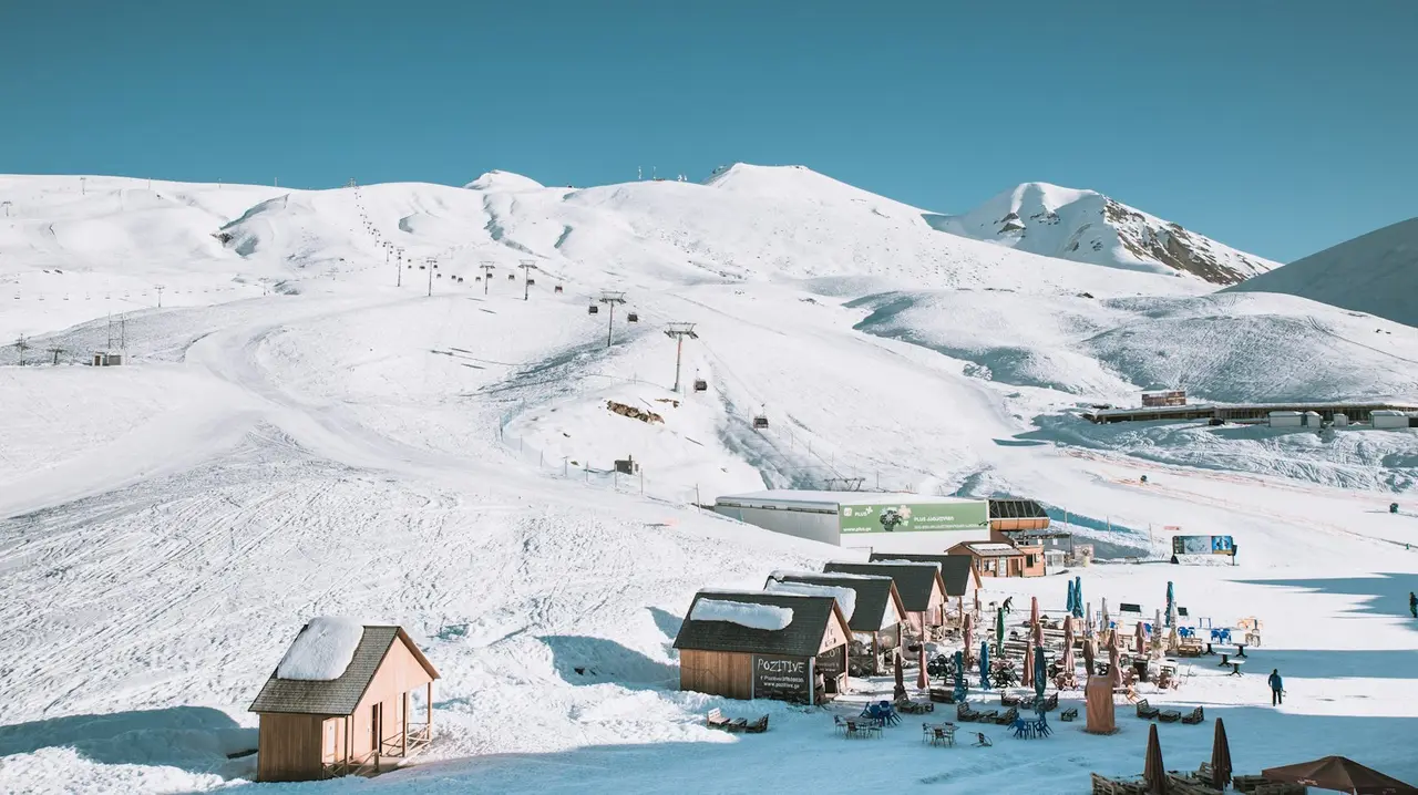The snowy slopes of a ski resort with a lift in winter