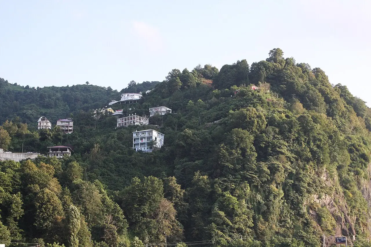 Guesthouses and hotels on a steep green slope above Kvariati