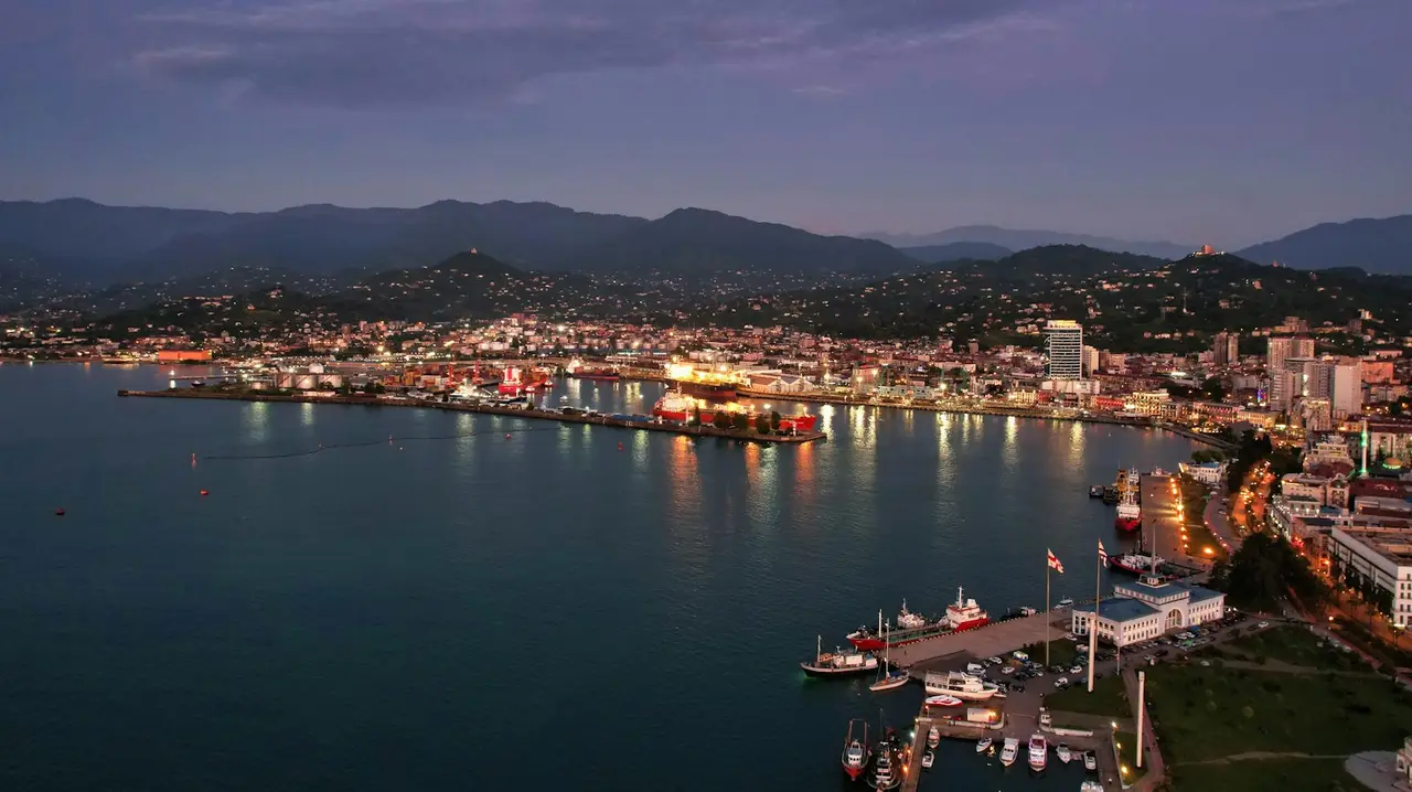 Batumi at dusk with the lit-up seafront and the Black Sea