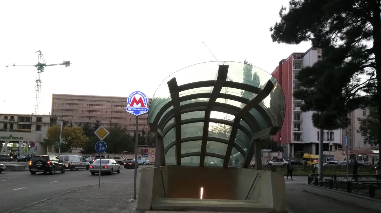 A Tbilisi metro station entrance and city traffic