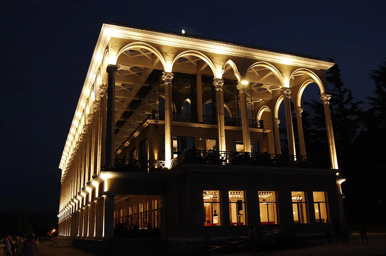 The lit-up upper funicular station building on Mtatsminda at night
