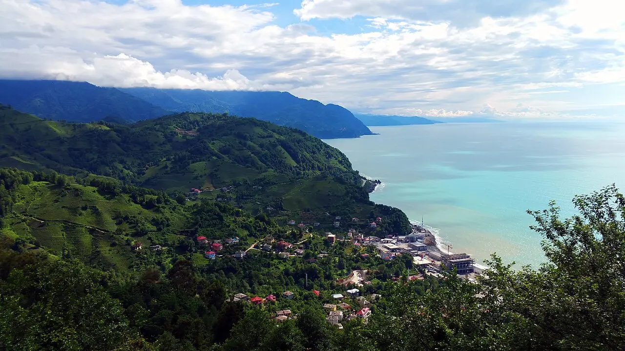 Turquoise sea and green hills by the village of Sarpi on the Adjara coast