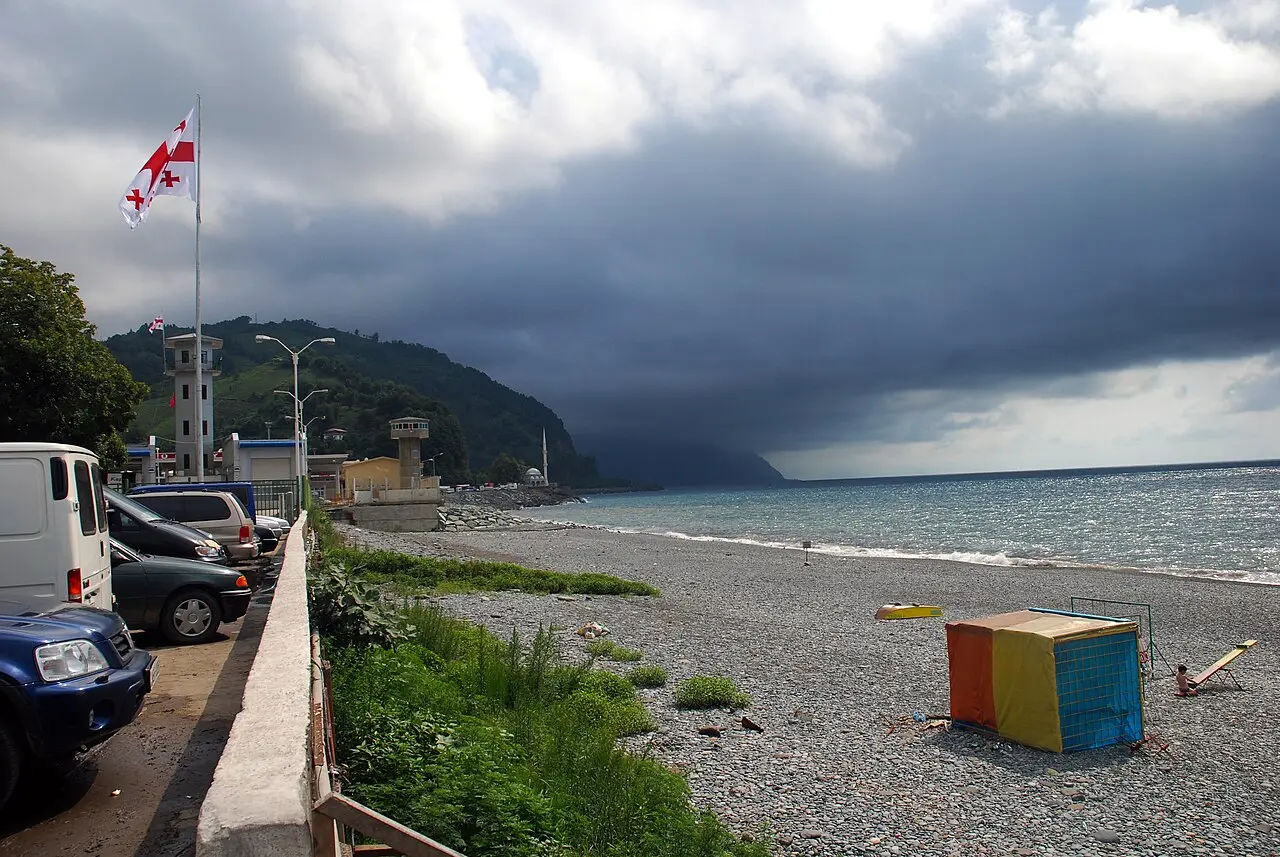 Pebble beach at Sarpi with a Georgian flag by the Turkish border