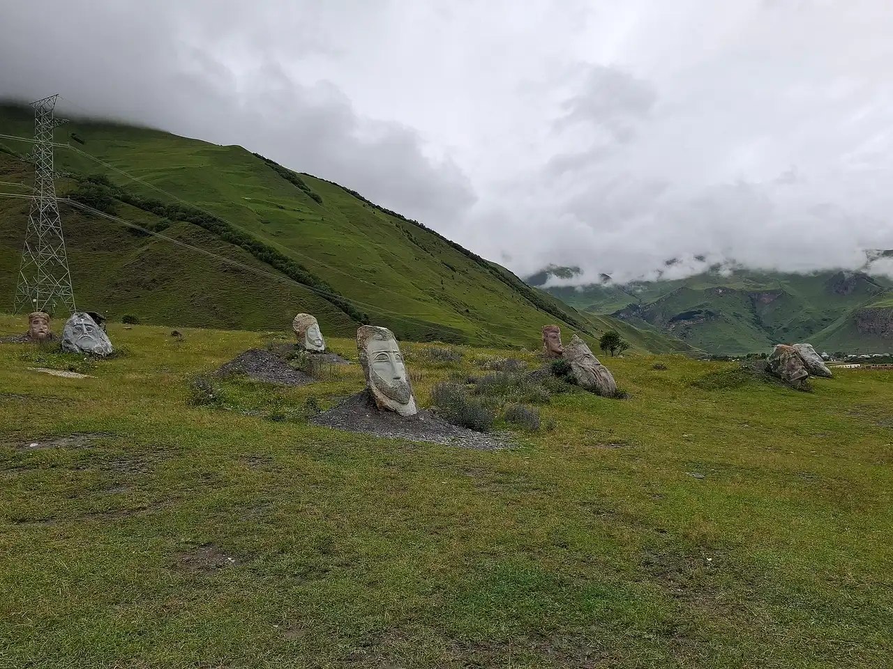 Giant stone heads by Merab Piranishvili in the Sno valley