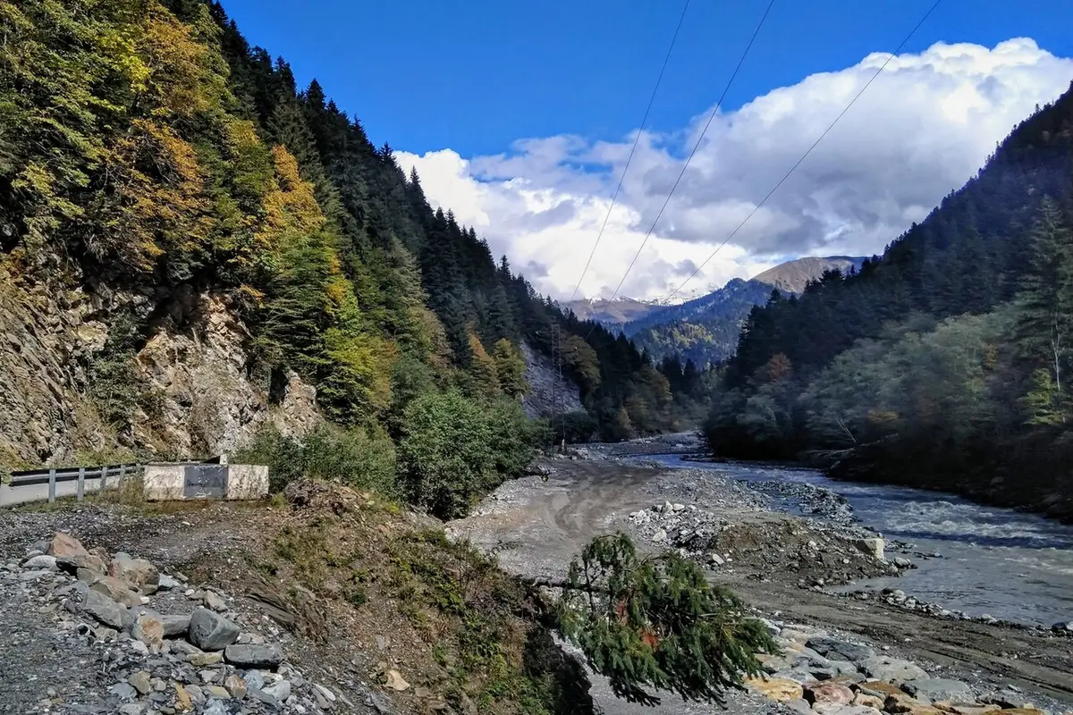 The Rioni gorge in Upper Racha: wooded slopes, the river and a road along the drop