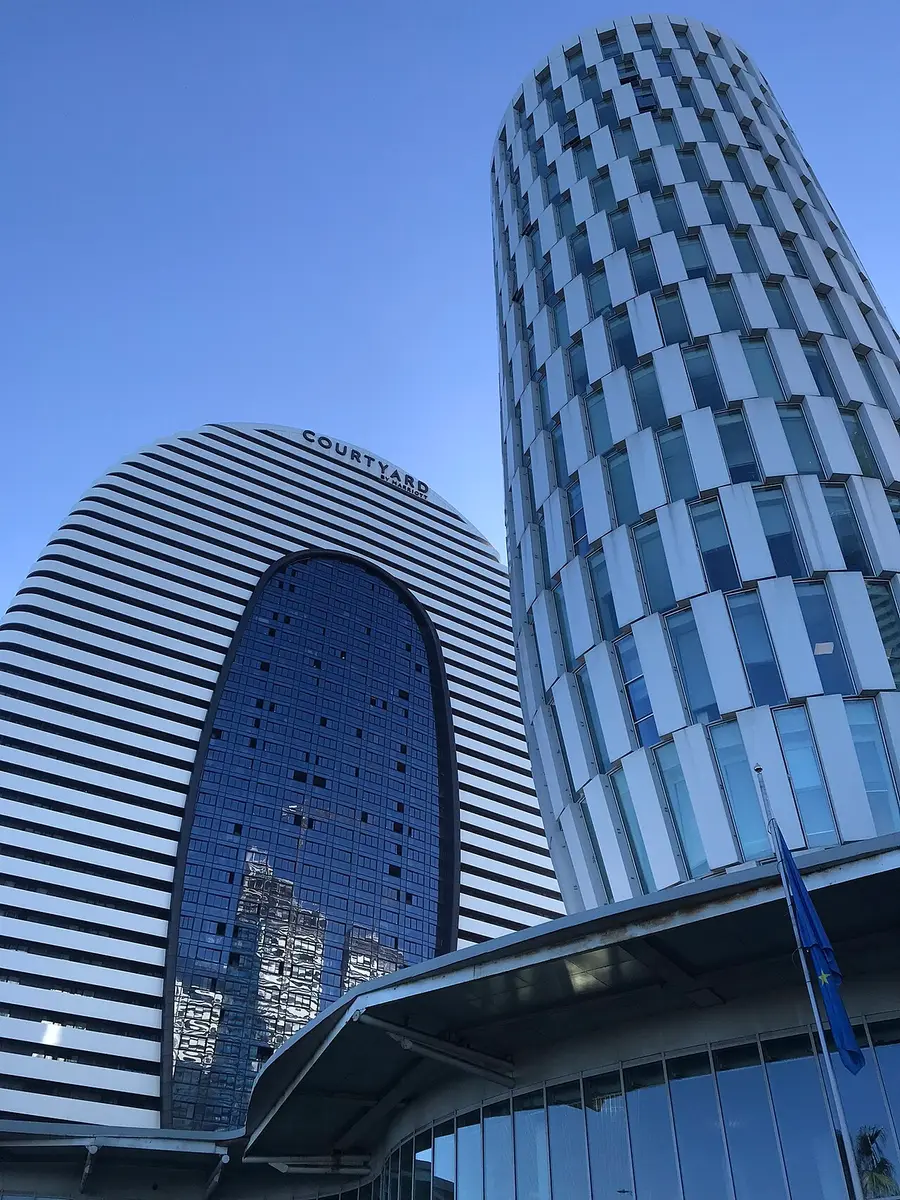 The Public Service Hall building in Batumi next to high-rise towers