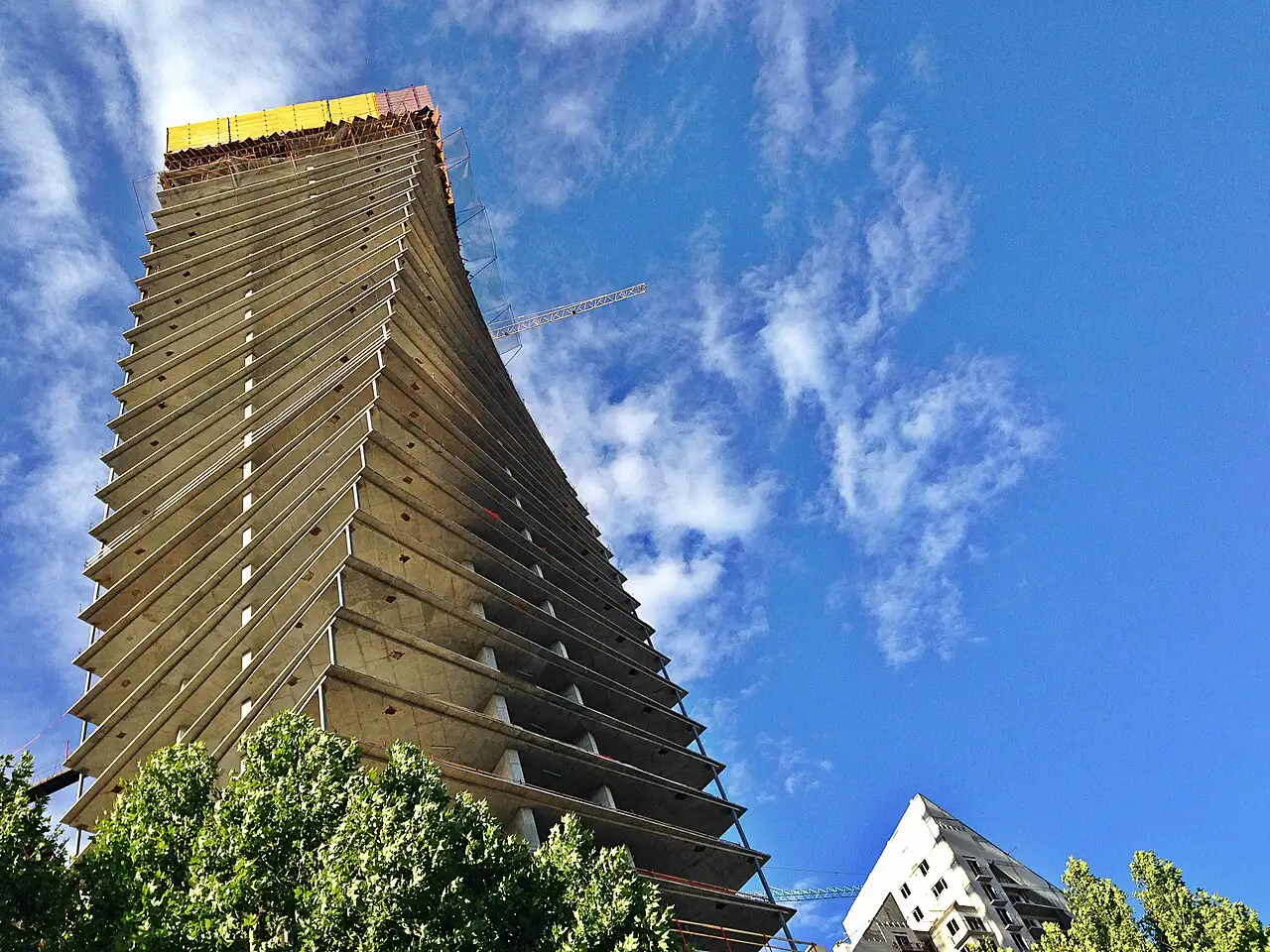 The Axis Towers building under construction in Tbilisi against a blue sky