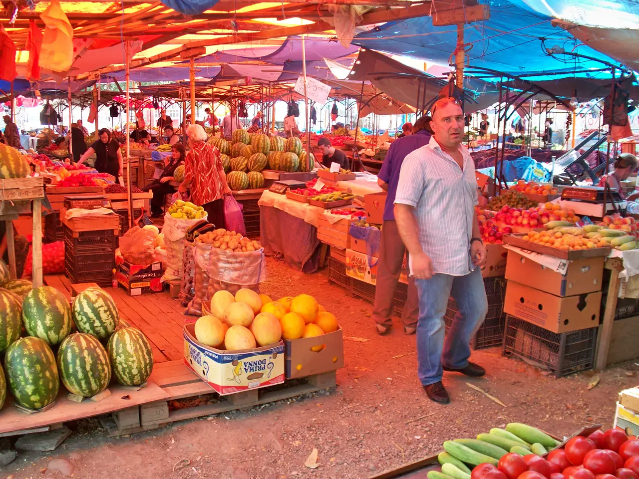 A produce market in Tbilisi: fruit and vegetables under awnings