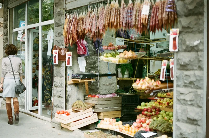 A stall with churchkhela, nuts and fruit at a Tbilisi market