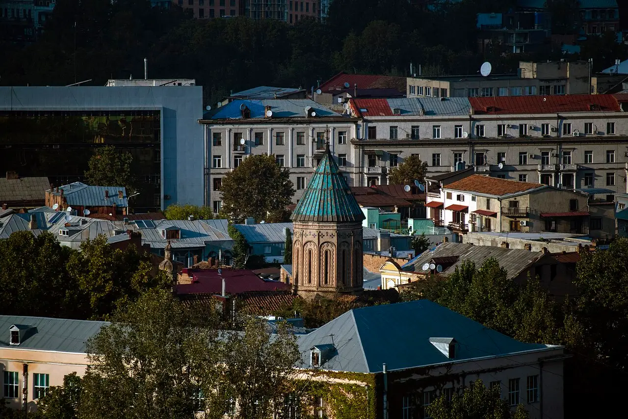 Panorama of residential districts of Tbilisi with hills on the horizon