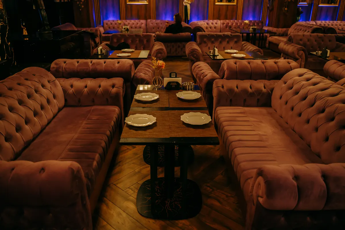 The Teatro lounge area with velvet sofas and set tables