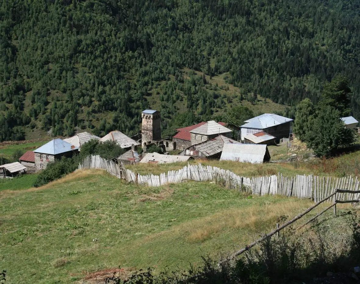 The Svan village of Iprari with a tower on a forested slope