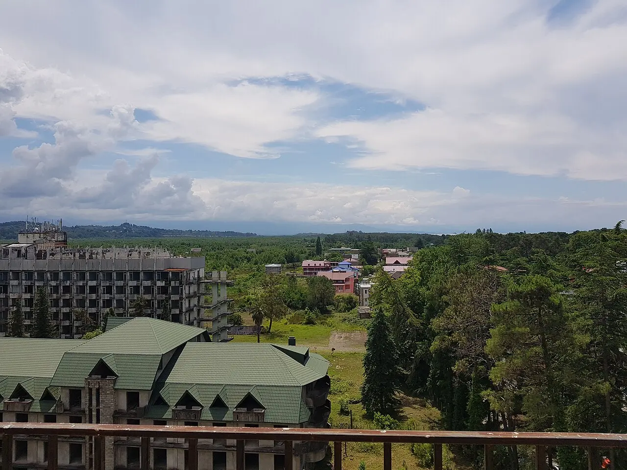 View over Ureki resort: green-roofed sanatoriums among pines and the coastal plain