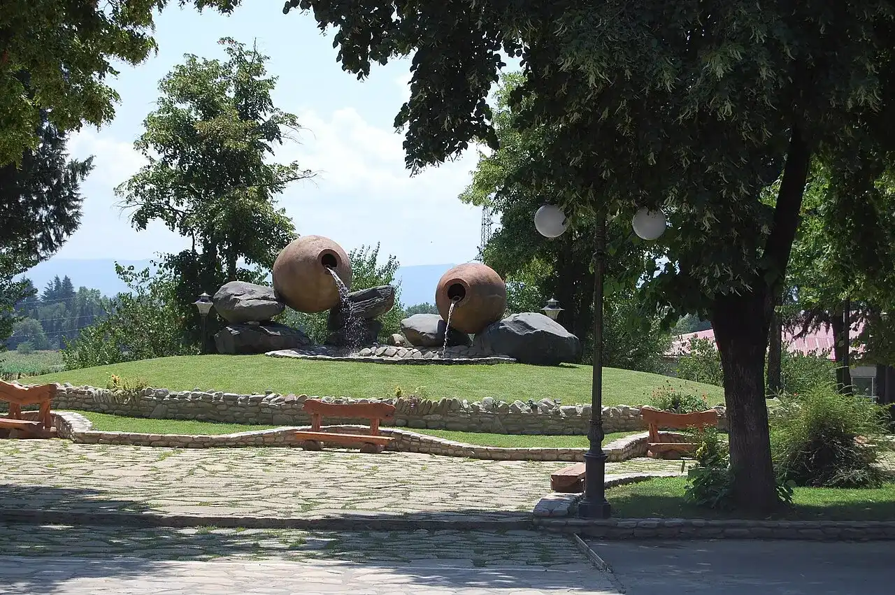 Decorative fountain shaped like giant clay qvevri jars in a garden at a Kakheti winery