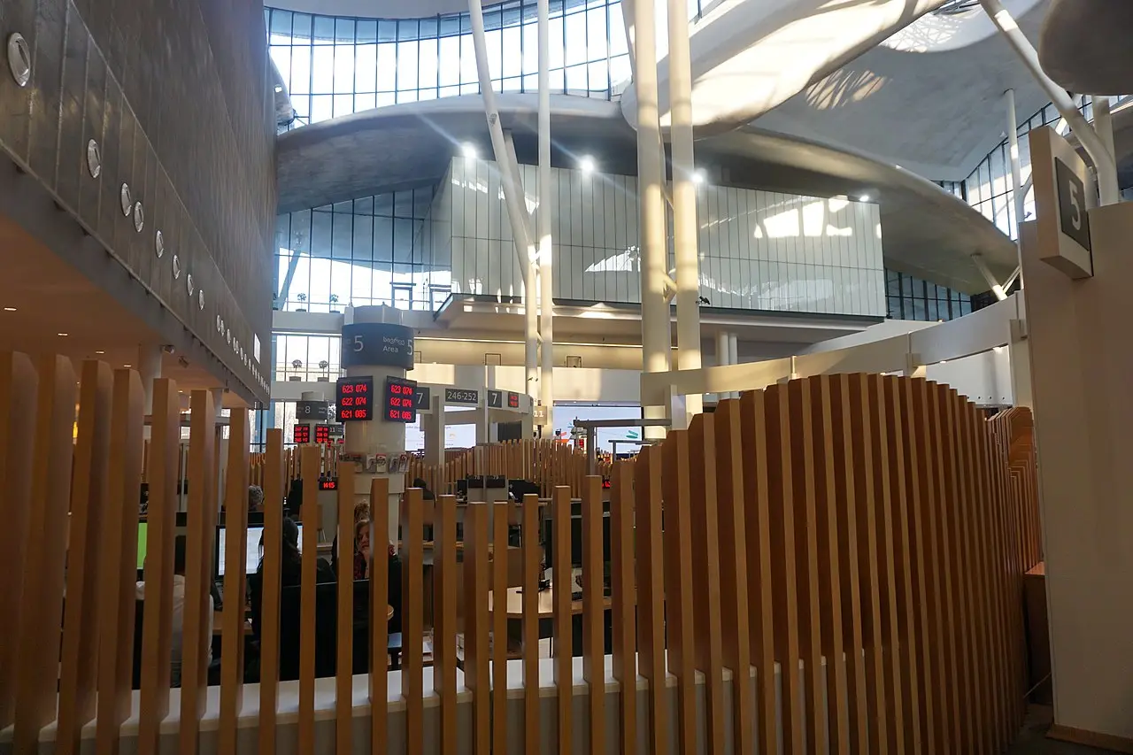 Service counters with numbered windows and an electronic queue inside the Public Service Hall in Tbilisi